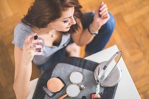 woman using perfume 